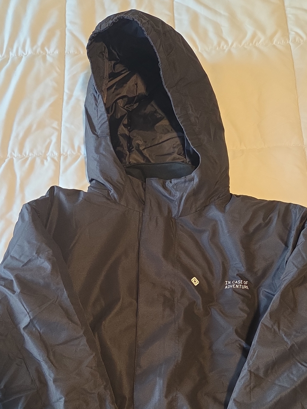 Black Hooded Windbreaker Jacket with 'In Case of Adventure' Accent